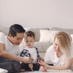 A joyful family drawing together indoors, fostering love and creativity.